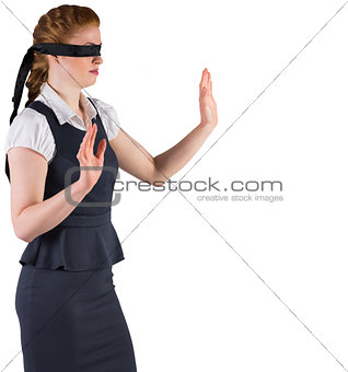 Redhead businesswoman in a blindfold
