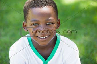 Cute boy smiling at the camera in the park