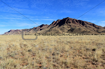 Grassy Savannah with mountains in background, Namibia