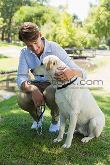 Handsome man with his labrador in the park