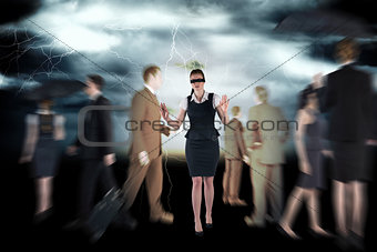 Composite image of redhead businesswoman in a blindfold