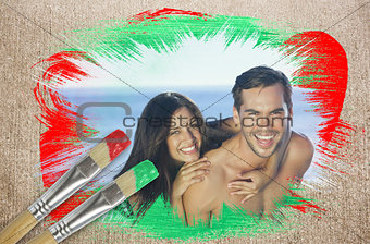 Composite image of attractive couple at the beach