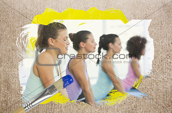 Composite image of yoga class in the gym