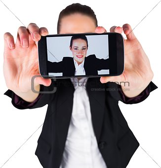 Businesswoman taking a selfie on smartphone