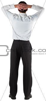 Businessman standing back to the camera with hands on head
