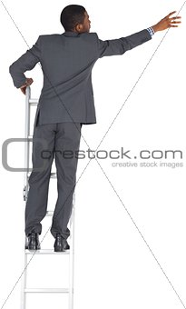 Businessman standing on ladder