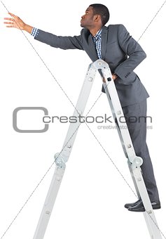 Businessman climbing up ladder