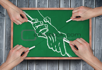 Composite image of multiple hands drawing handshake with chalk