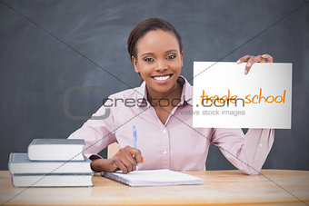 Happy teacher holding page showing trade school