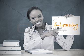 Happy teacher holding page showing e learning