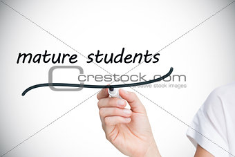 Businesswoman writing the words mature students