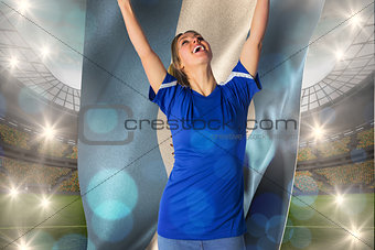 Composite image of cheering football fan in blue jersey holding argentina flag