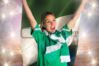 Composite image of cheering football fan in green jersey holding nigeria flag
