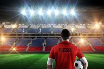 Composite image of russia football player holding ball