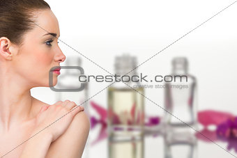 Composite image of beautiful brunette with arms over chest