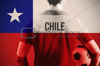Composite image of chile football player holding ball
