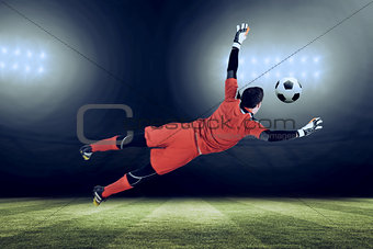 Composite image of fit goal keeper jumping up