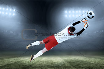 Composite image of goalkeeper in white jumping up