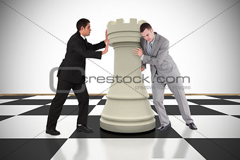 Composite image of business people pushing chess piece