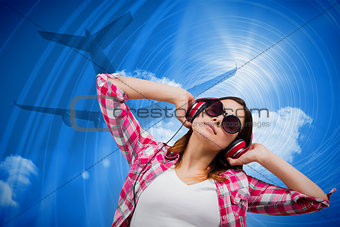 Composite image of casual brunette listening to music