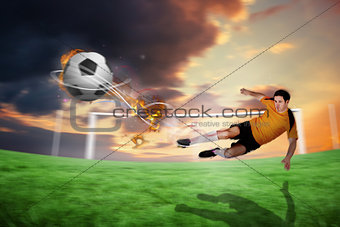 Composite image of football player in orange kicking