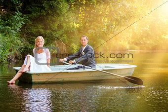 Young just married bride and groom on boat