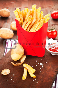French fries in red paper bag.