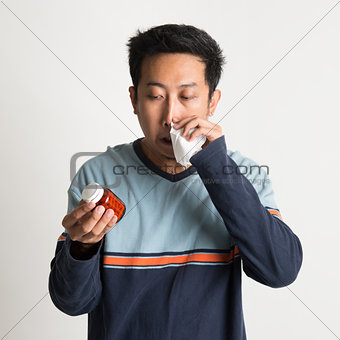 Asian male sneezing 