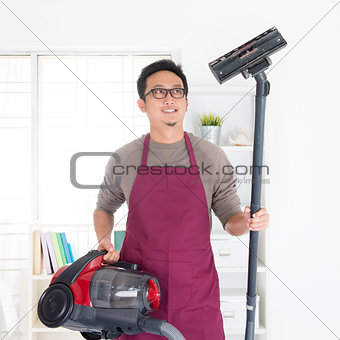 Asian man vacuuming