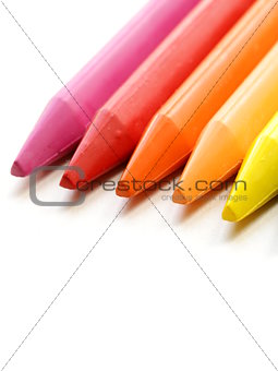 multicolored pencil crayons on a white background