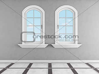 Gray room with two arched windows