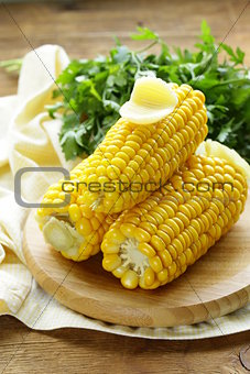 fresh boiled cob corn on a wooden plate