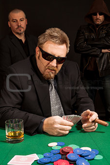 Cigar smoking whisky drinking poker player