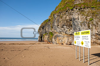 beach cliff falls warning sign