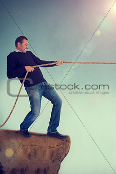 man tug of war pulling rope