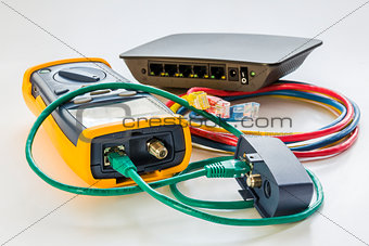 network tester and small switch with various color RJ45 cables c