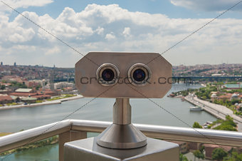 Binoculars on viewing platform overlooking river