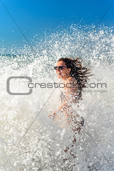 Girl bathes in a storm at sea, laughter, joy