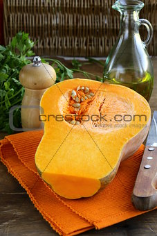 fresh raw pumpkin sliced on a wooden table
