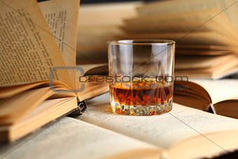 Glass of whiskey on books