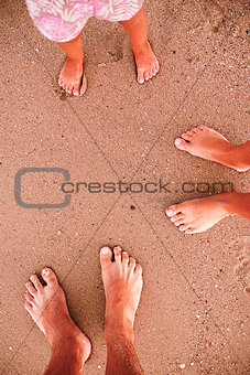 family footprints in the sand on the beach