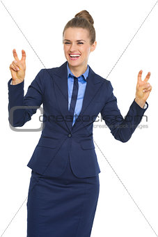 Smiling business woman making finger quote marks