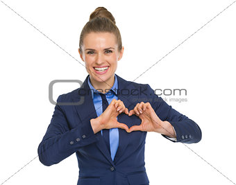 Portrait of happy business woman showing heart with fingers