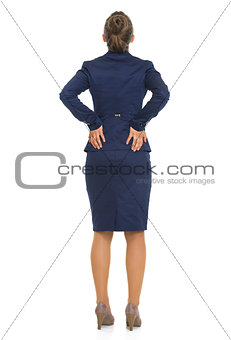 Full length portrait of business woman with back pain. rear view
