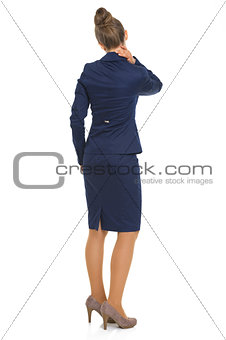 Full length portrait of business woman with neck pain. rear view