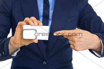 Closeup on business woman pointing on business card