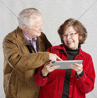 Man Looking at Woman's Tablet