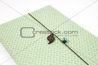 Notebook with green cover isolated on white background