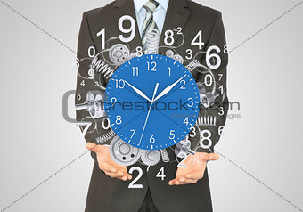 Businessman hold clock with springs and gears