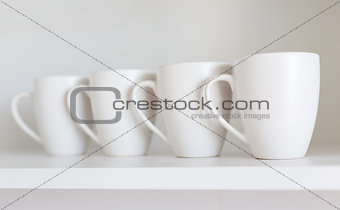 white cups on the shelf